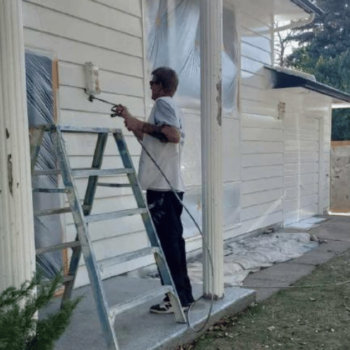 painter on demand painting a house